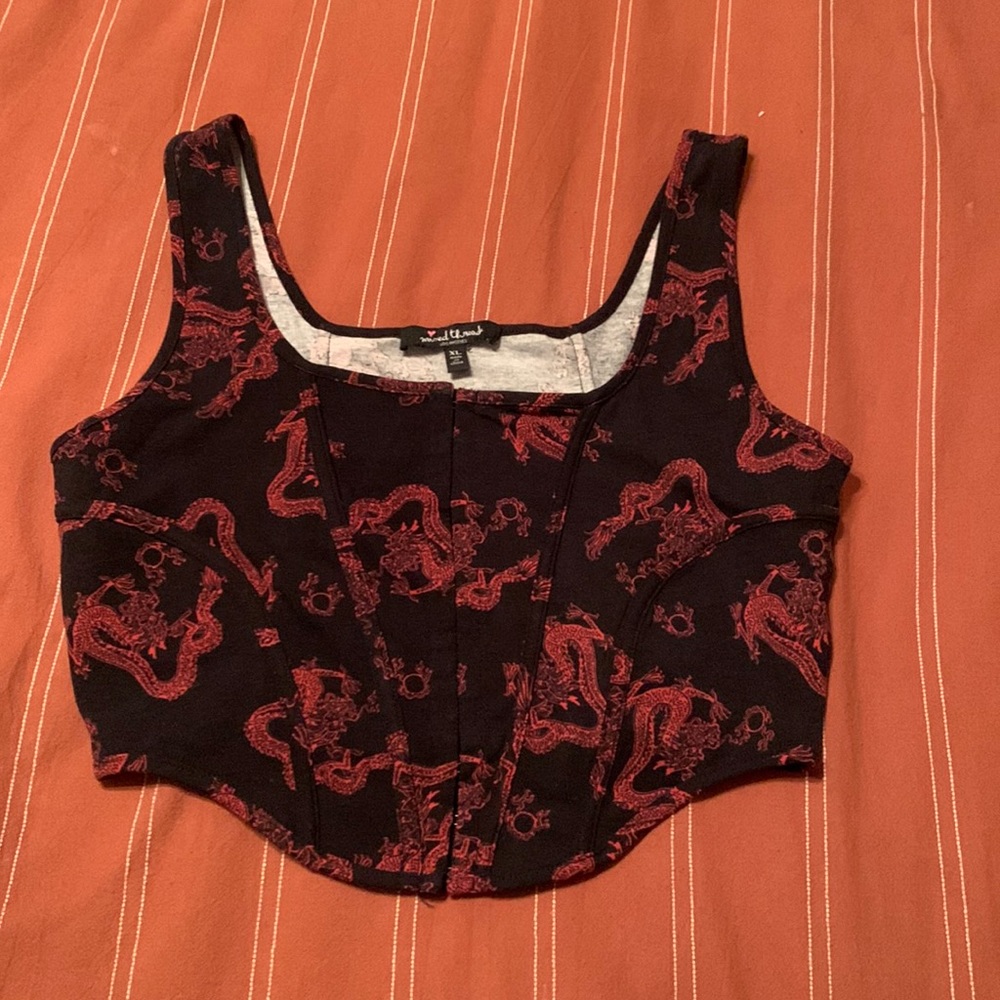 Black and red “Mixed Threads” crop top with fasteners in front.